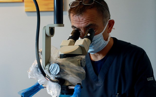 dentist using microscope