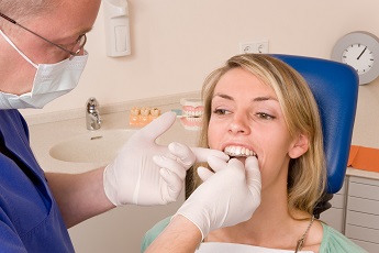 Dentist checking fit of ClearCorrect tray