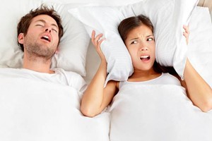 Man snoring in bed