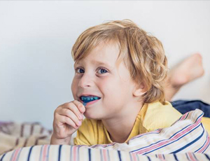 Young boy placing his Myobrace appliance