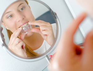 Teen girl placing her myobrace appliance