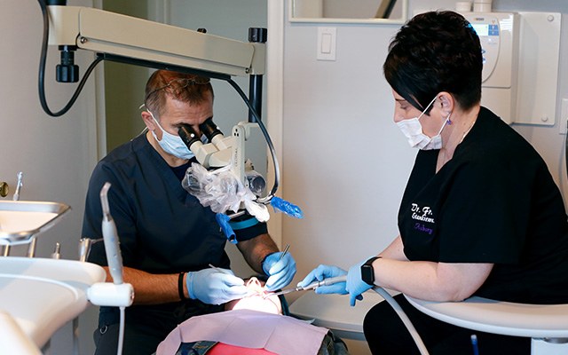 dentist and assistant working on patient