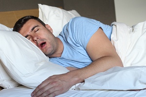 Man snoring in bed